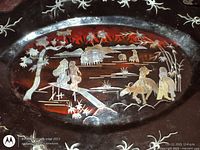 Close-up of tray showing inlaid figures, animals and bridge scene