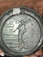 Front view showing bagpiper scene and scalloped rim