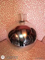 Front view of spherical silver mirrored glass vase with neck