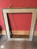 Full view of rectangular wooden frame leaned against wall