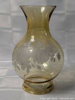 Full front view of amber glass oil lamp shade showing floral etching and overall shape