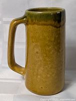 Front view showing full height, glaze color, cylindrical form