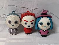 Front view of three Disney Nightmare Before Christmas character ornaments Lock, Shock and Barrel