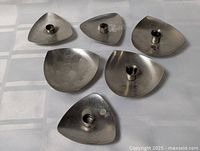 All six triangular candle holders displayed top view showing form and finish