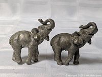 Both elephant figurines front view