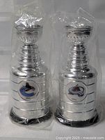 Front view of both sealed mini Stanley Cups showing team logos