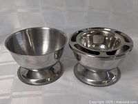 Both stainless steel bowls side by side showing size and design differences