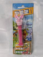 Front view of sealed Piglet PEZ dispenser package showing entire product