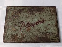 Top view of worn Player's cigarette tin