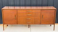 Full front view of teak sideboard showing drawers, cabinet doors, legs and overall condition