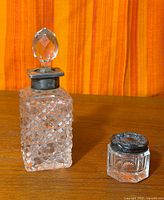 Both crystal pieces side by side on wooden surface