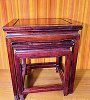 Front view of nested cherrywood tables showing design and finish