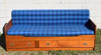 Front view of Danish teak day bed showing blue plaid cushions and two storage drawers