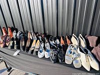 Full row of assorted women’s shoes on table