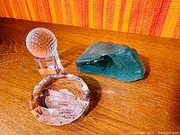 Overall view of three paperweights on wooden surface