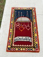 Full view of prayer rug showing design and colours
