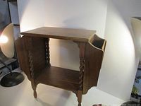 Full view of wooden two-tier magazine table front angle