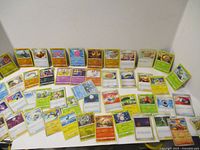 Spread of assorted Pokémon TCG cards showing variety of types and artwork