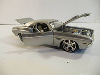 Left front view with hood and driver door open showing engine and interior