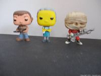 Front view of all three Funko Pop figures together