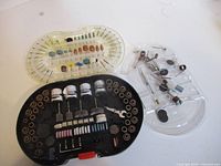 Overview of three plastic trays with Jobmate rotary tool accessories