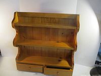 Front view of pine shelf showing shelves and drawers