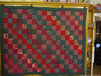 Full front view of quilt hanging, showing overall pattern and size