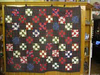 Full view of front showing plaid field and nine-patch blocks