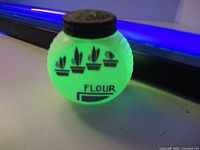 Front view showing stencil design and FLOUR label glowing under UV