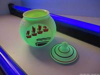 Jar and lid under UV light showing fluorescence and decoration
