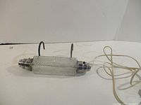 Full view of headboard light with cord and hooks