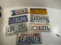 Seven license plates laid out for overview