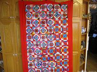 Full view of geometric patchwork side with red border