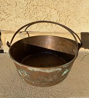 Full view of copper cauldron with iron handle