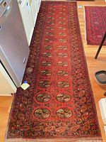 Full view of burgundy runner rug on floor