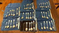 Overview of entire sterling flatware set in six rolls