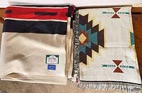 Both blankets folded side by side showing Pendleton label and fringe