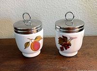 Two Royal Worcester egg coddlers with lids on view