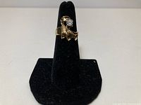 Full view of 10K gold ring on stand showing stone and design