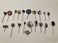 overview of 20 enamel stick pins laid flat