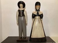 Full view of both carved Pilgrim figures standing side by side