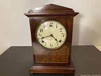 Full front view of Gilbert key-wind mantel clock showing case and dial