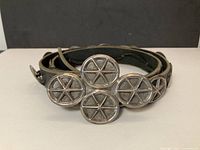 Front view of rolled belt showing buckle and conchos