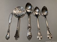 All five silver pieces laid out side by side