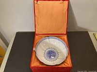 Bowl inside presentation box, showing box exterior and lining