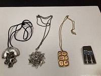 Full view of four jewelry pieces laid out