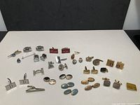 Full lot layout showing all cufflinks, tie clips and tacks
