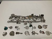 Both charm bracelets with attached charms laid flat