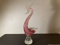 Full view of pink ribbed Murano glass swan on clear base