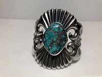 Front view of silver cuff with turquoise stone